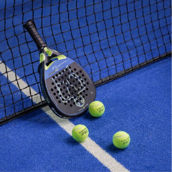 Padel racket and balls on a blue court